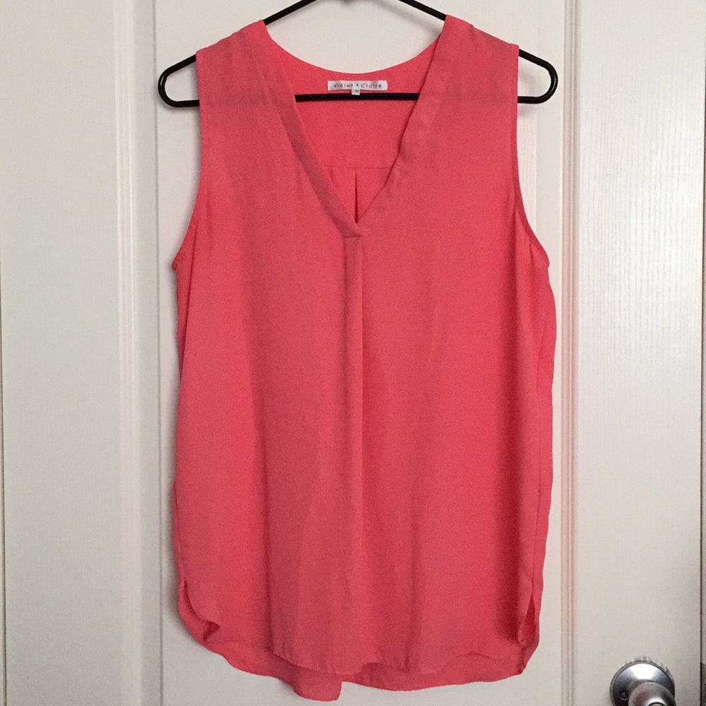 Pink sleeveless blouse.